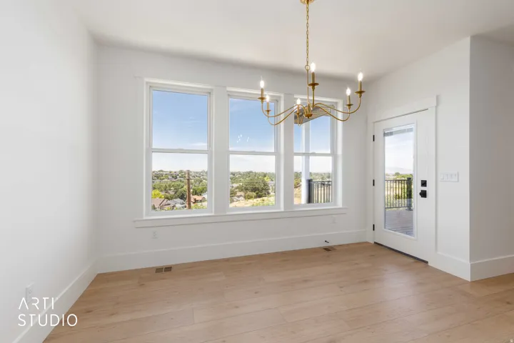 Light wood-finish flooring complements the white walls and trim