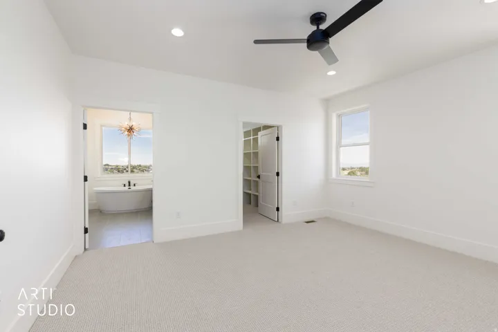 Spacious room with light-colored carpeting and white walls