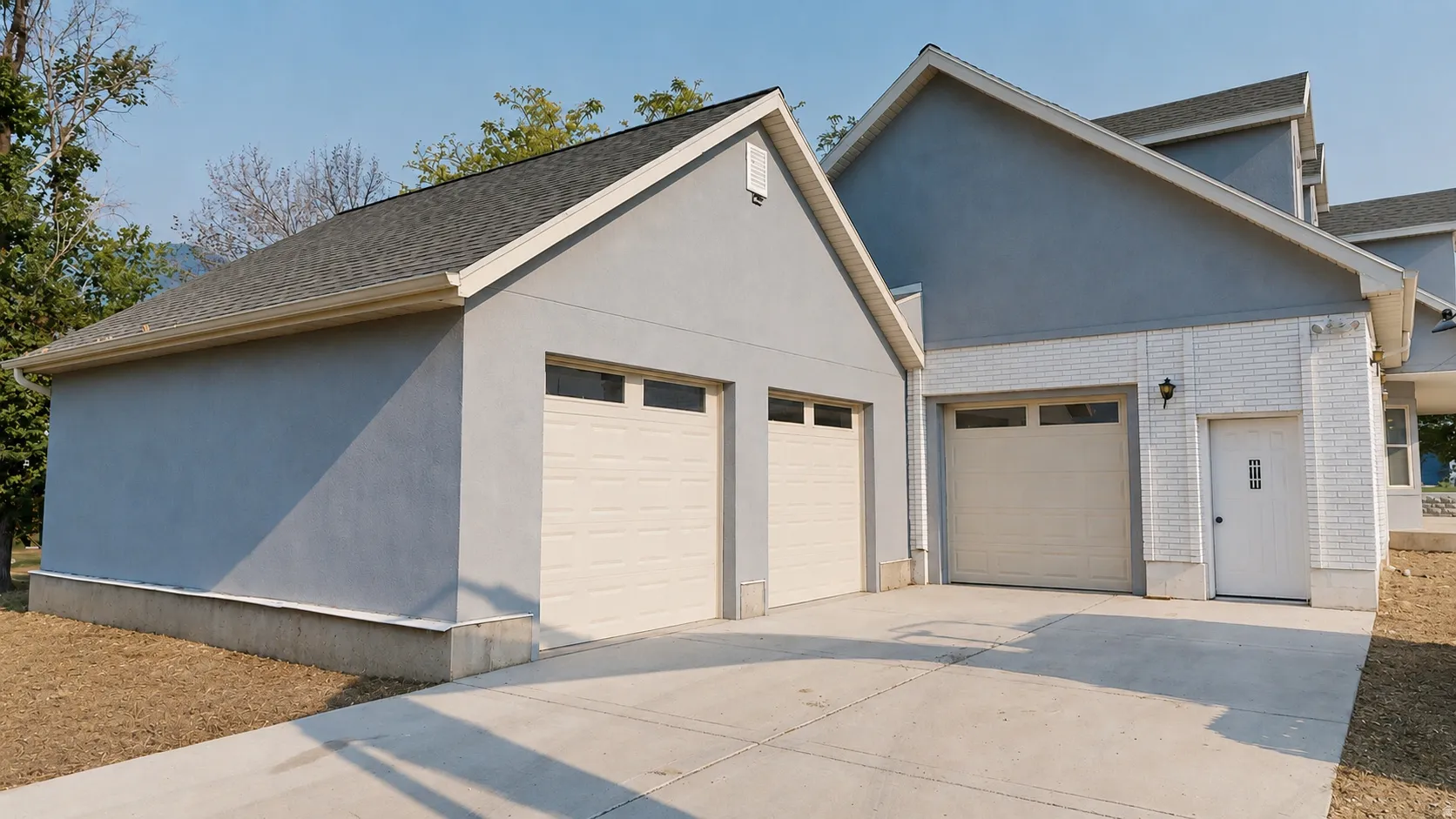 Ai enhanced photo. Three-car garage with two separate bay doors featuring window inserts