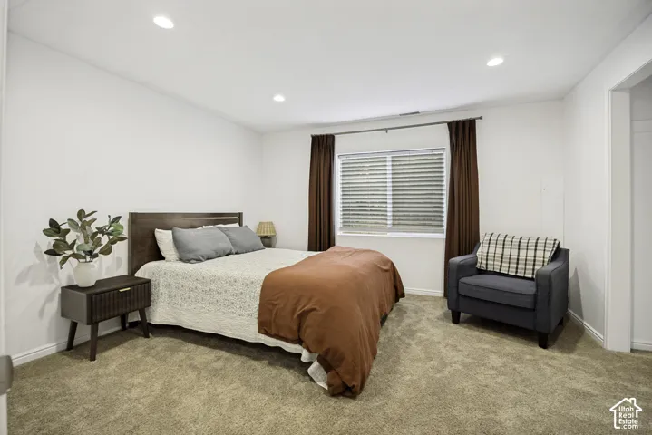 Spacious room featuring neutral carpeting and white walls