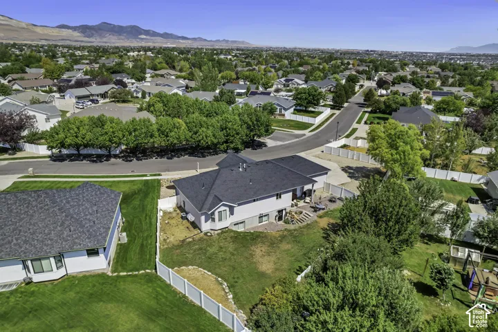 Single-family residence featuring a two-story design with a light-colored exterior and a dark shingle roof