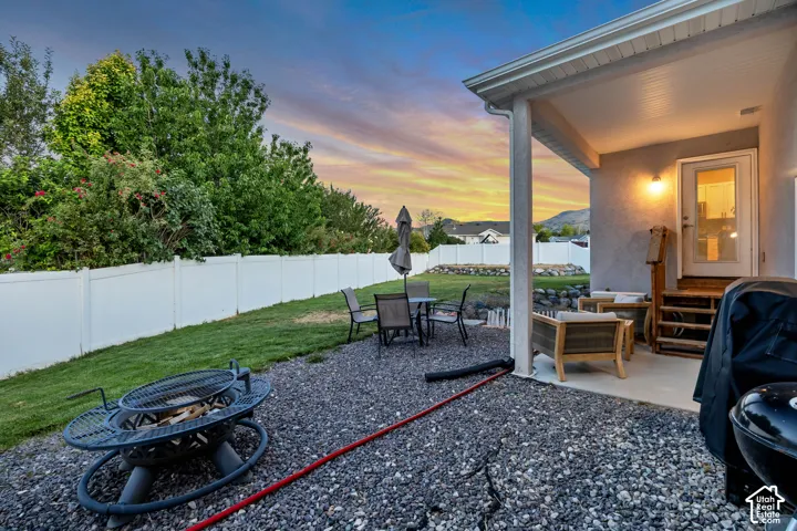 Covered patio with an exterior light fixture and a glass-paneled door