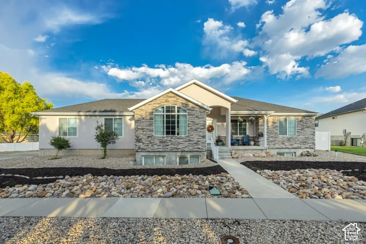 Ranch-style exterior with a partial stone facade and stucco accents