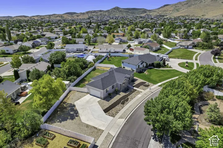 Aerial perspective showcasing a residential neighborhood with mountain backdrop