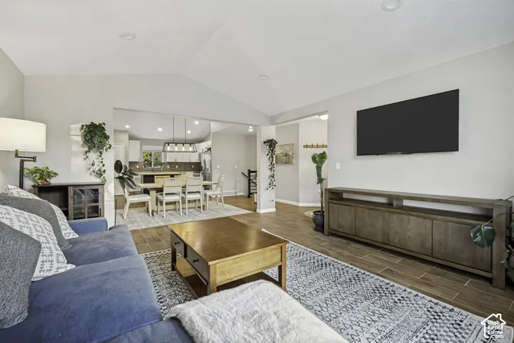 Vaulted ceilings and wood-finish flooring create an expansive living area