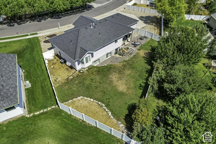 Spacious residential property featuring a gray shingle roof, light-colored siding, and a multi-level patio with stone steps