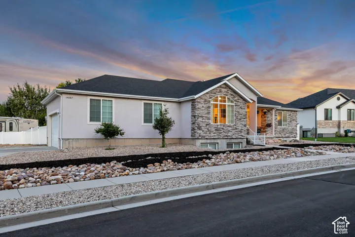 Contemporary stucco exterior featuring a stone accent fa