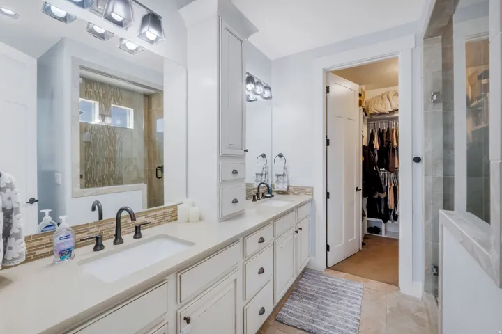 Dual vanity with undermount sinks and bronze-finish fixtures