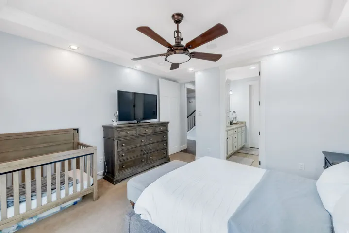 Recessed lighting, crown molding, and a ceiling fan with integrated light fixture