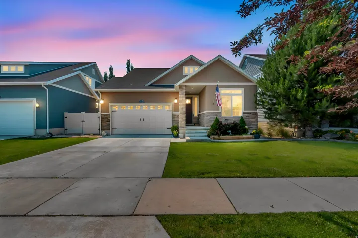 Two-story home featuring a stucco and stone exterior