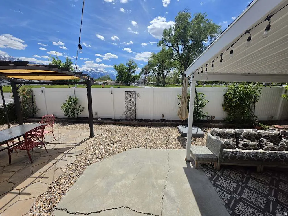 Outdoor living space featuring a concrete patio, pea gravel accents, and a flagstone paver area