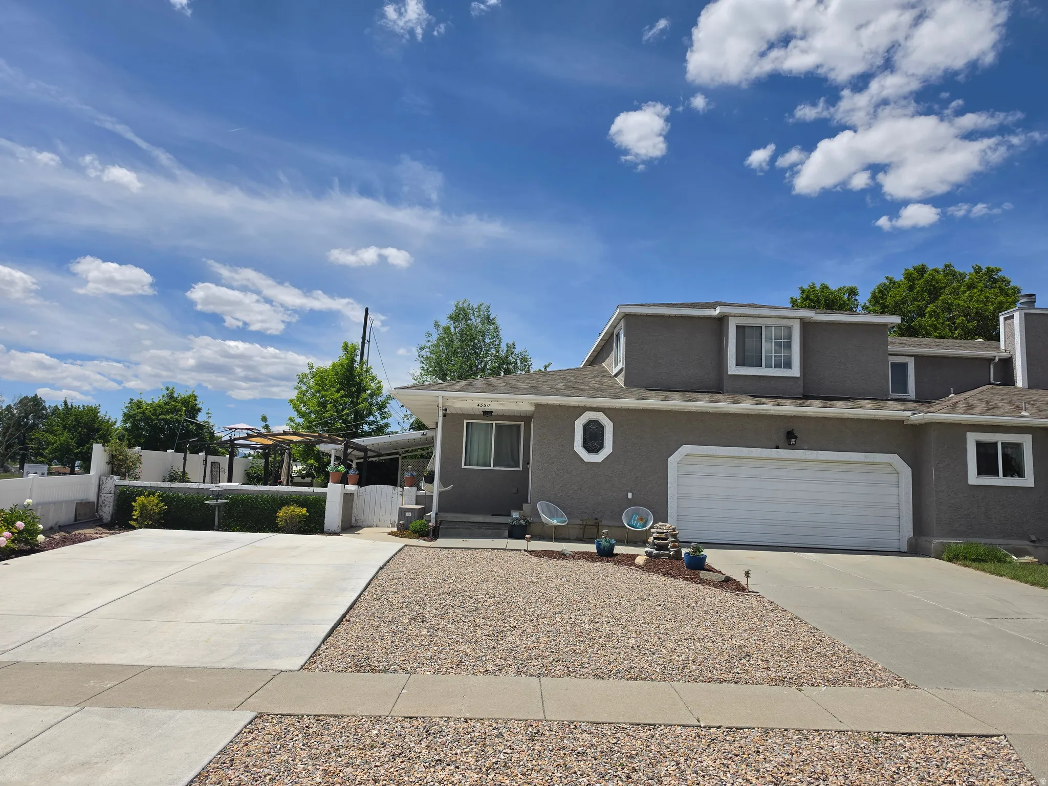 Stucco exterior residence featuring an attached garage with a white door