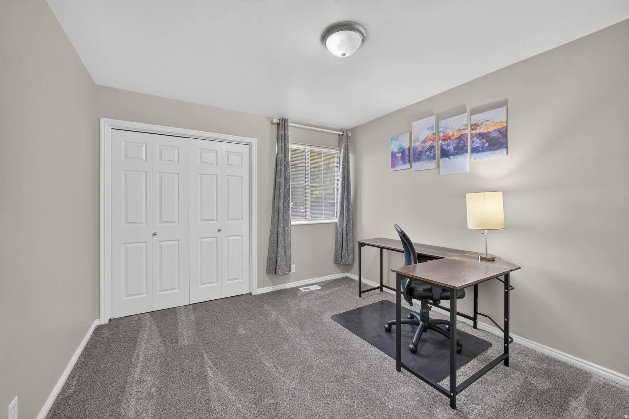 Room featuring gray wall-to-wall carpeting, neutral painted walls, and white baseboards