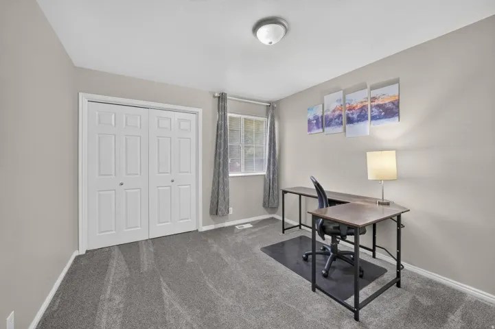 Room featuring gray wall-to-wall carpeting, neutral painted walls, and white baseboards