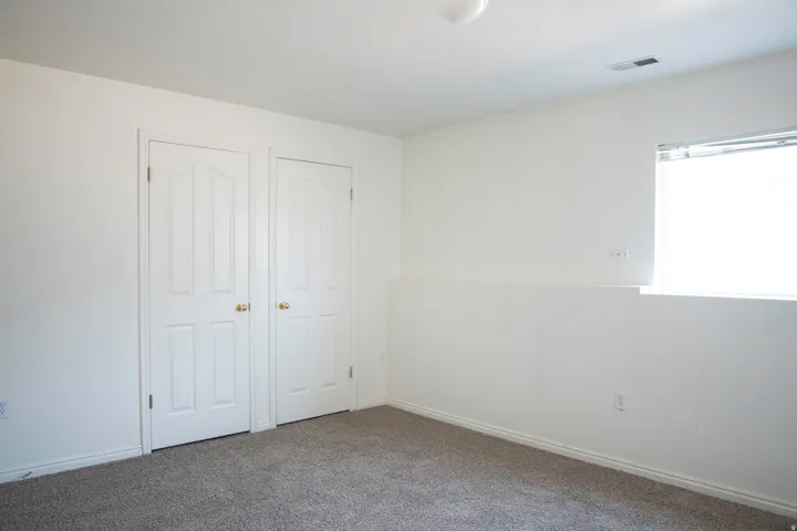 Neutral-toned carpeting complements the white walls and trim