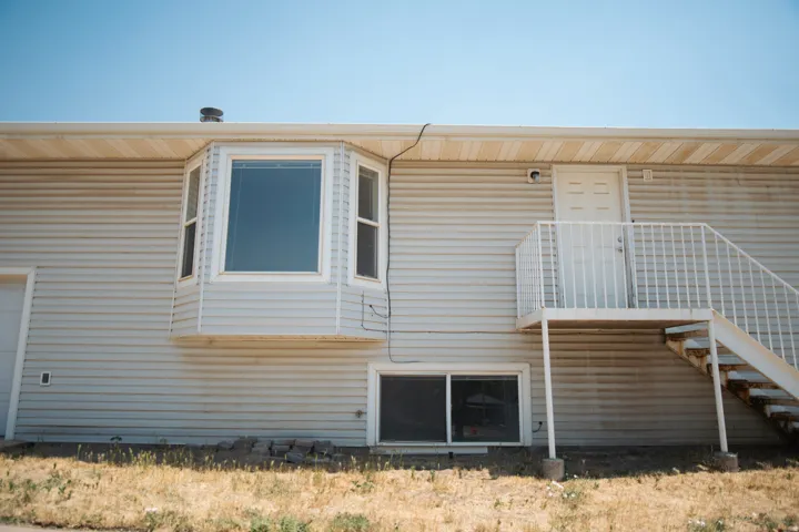 Light-colored siding exterior featuring a multi-pane bay window