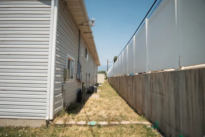 Exterior siding with multiple windows and exterior utility boxes