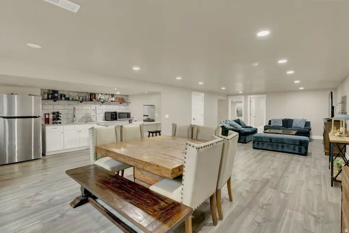 Spacious lower-level area featuring wood-finish flooring and recessed lighting