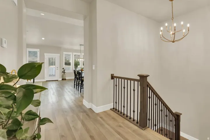 Staircase featuring dark wood handrail and decorative metal balusters