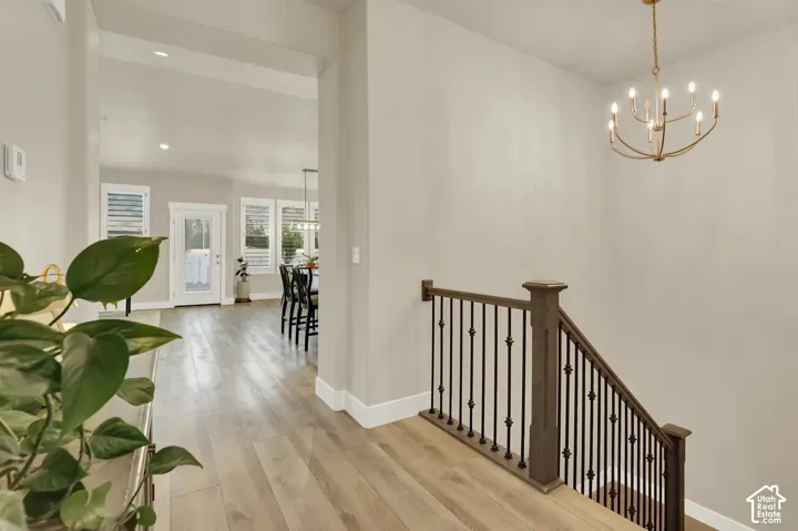 Staircase featuring dark wood handrail and decorative metal balusters