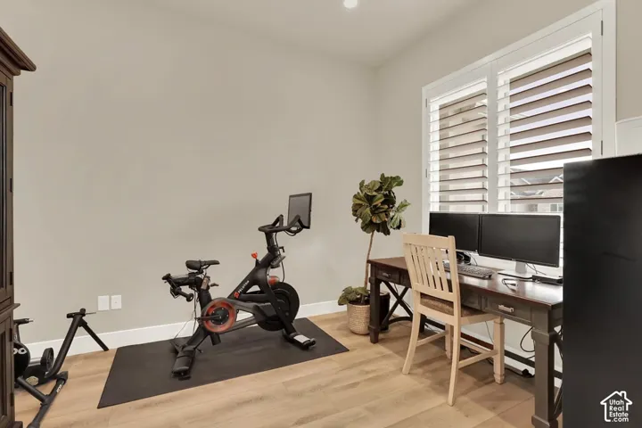 Light wood-finish flooring complements the neutral wall color in this versatile room