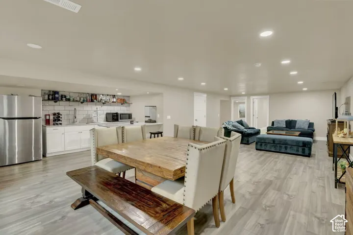 Spacious lower-level area featuring wood-finish flooring and recessed lighting