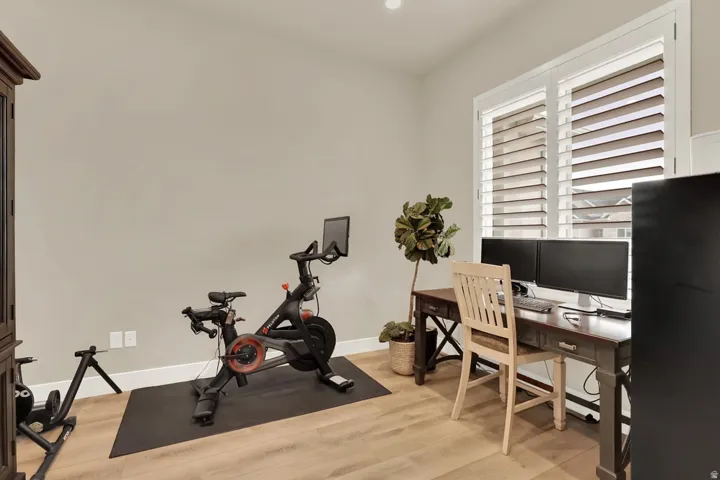Light wood-finish flooring complements the neutral wall color in this versatile room