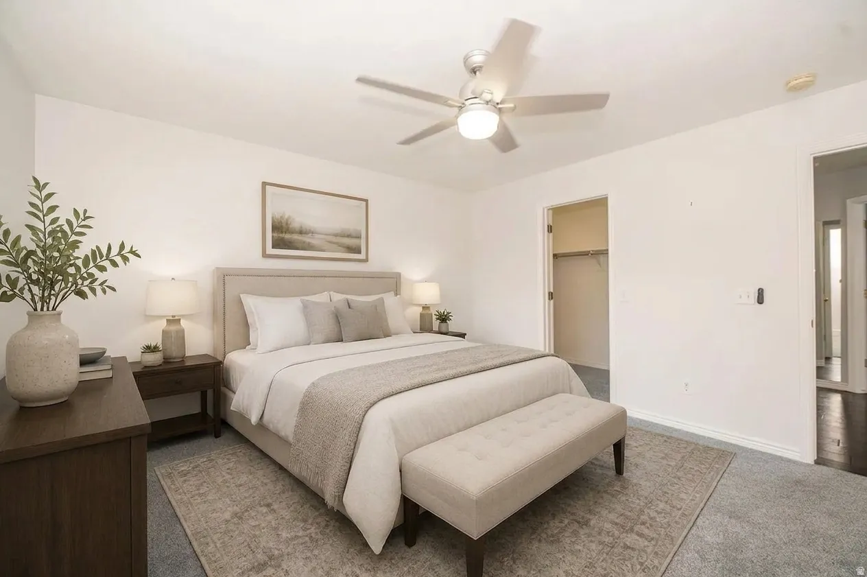 Recessed lighting, ceiling fan with integrated light, plush carpet flooring, and a walk-in closet with built-in shelving