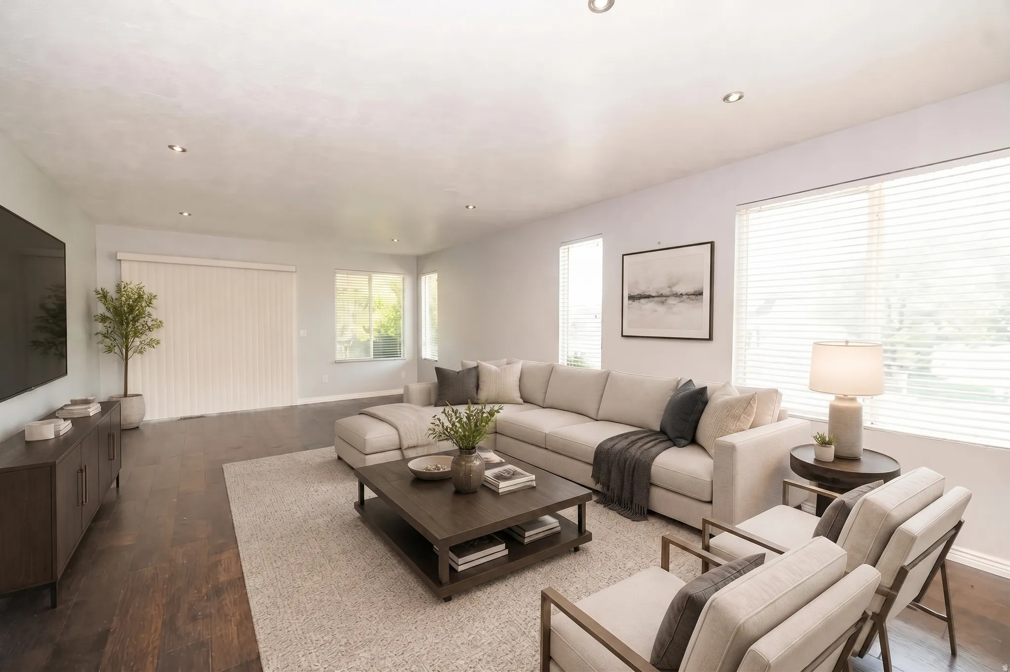 Recessed lighting illuminates wood-finish flooring