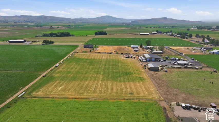 Expansive agricultural property featuring cultivated fields and multiple outbuildings