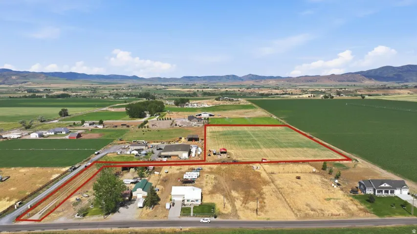 Aerial perspective showcasing extensive agricultural land and multiple structures