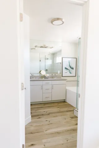 Dual vanity with undermount sinks, a light countertop, and brushed nickel faucets