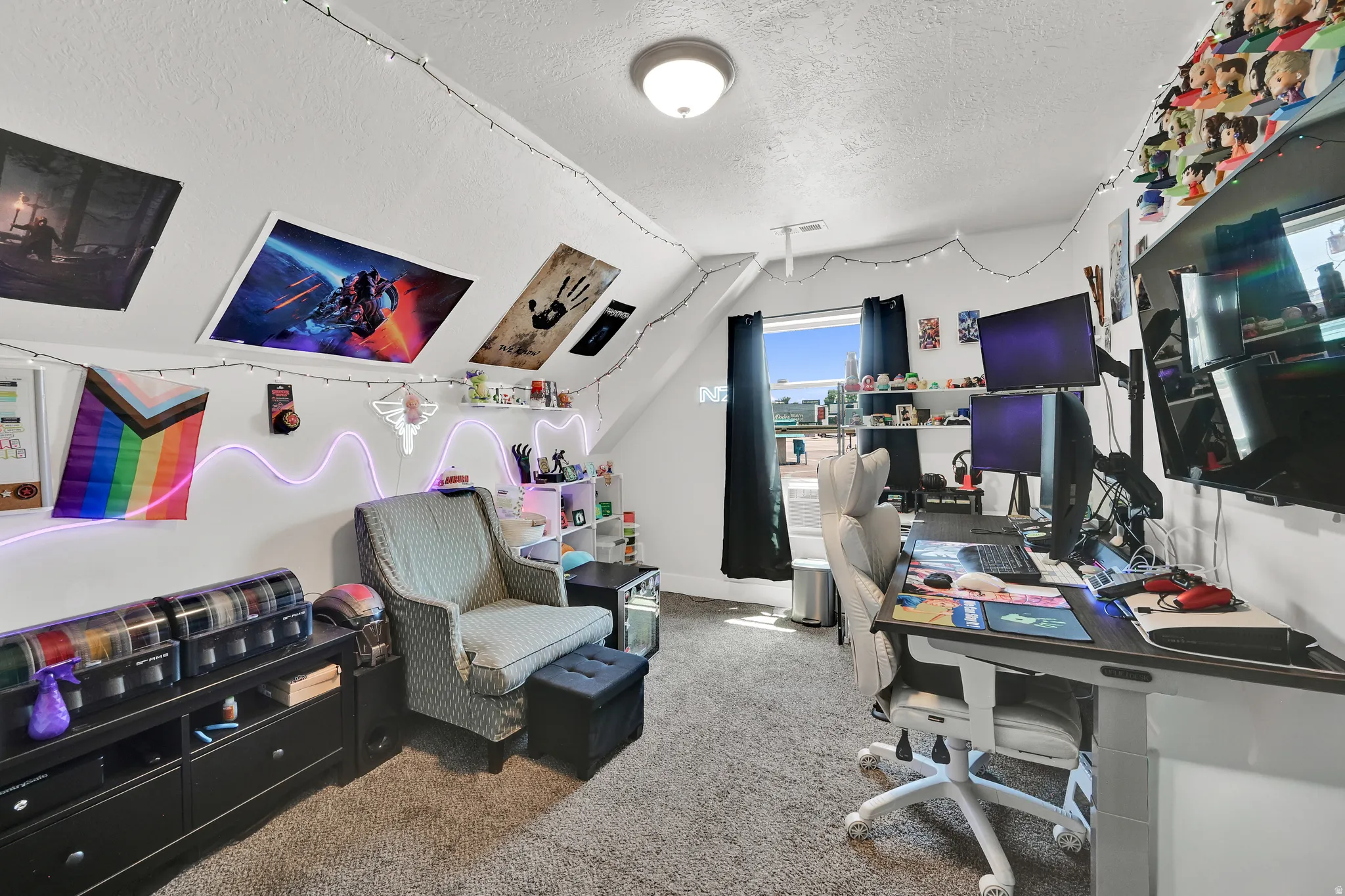 Carpeted room with sloped ceilings and a window offering natural light
