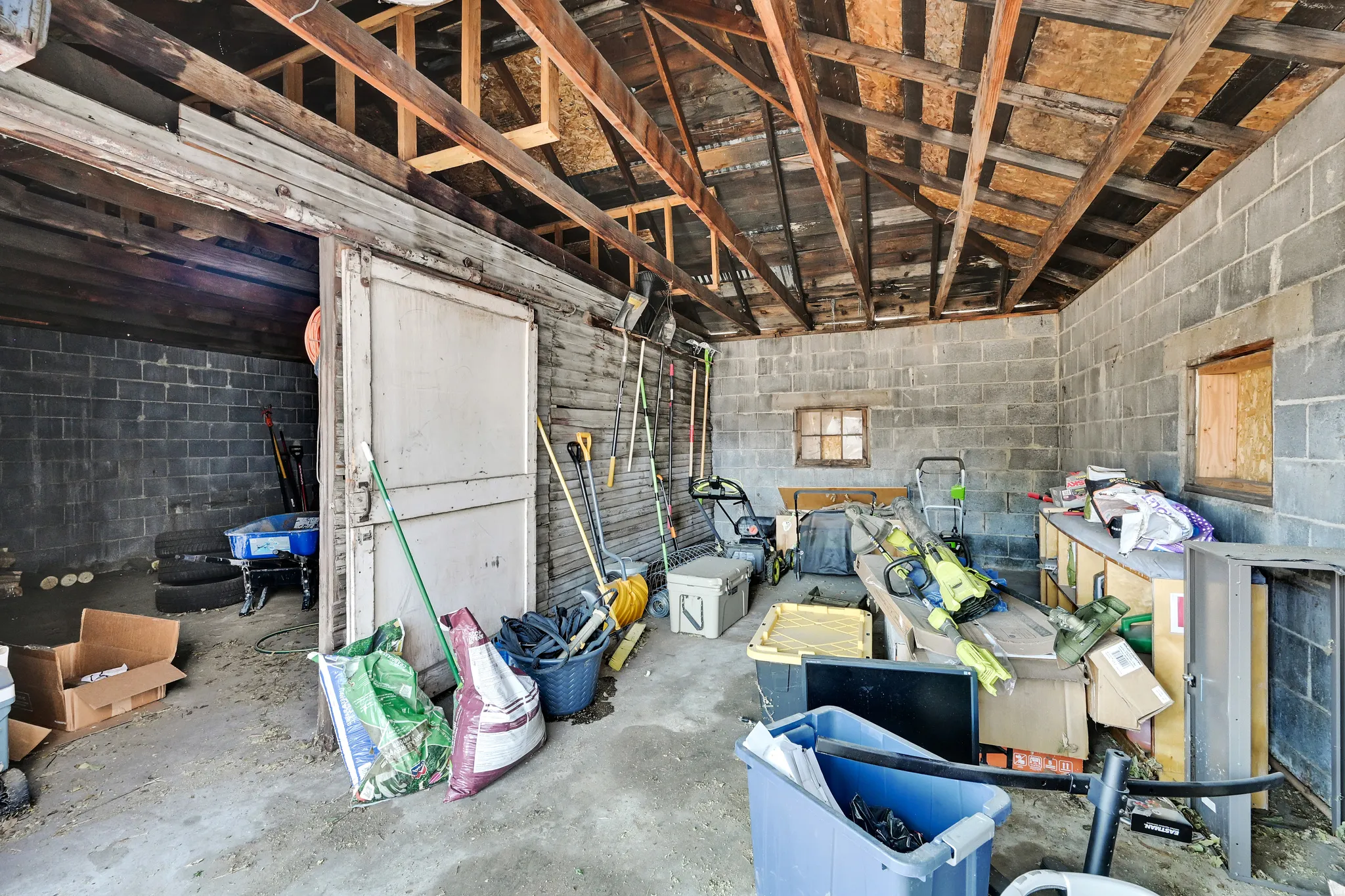 Structure featuring exposed wood ceiling joists and block walls