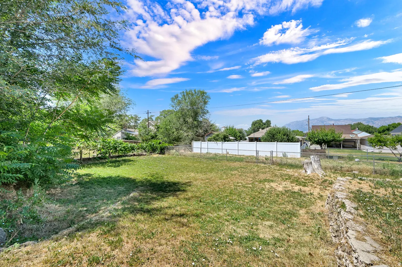 Expansive property featuring a mix of established trees and open lawn space