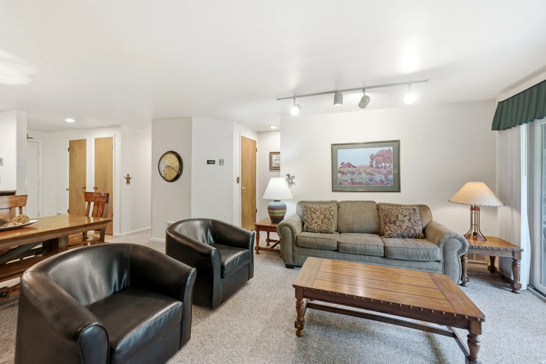 Neutral-toned carpeting extends throughout this living space