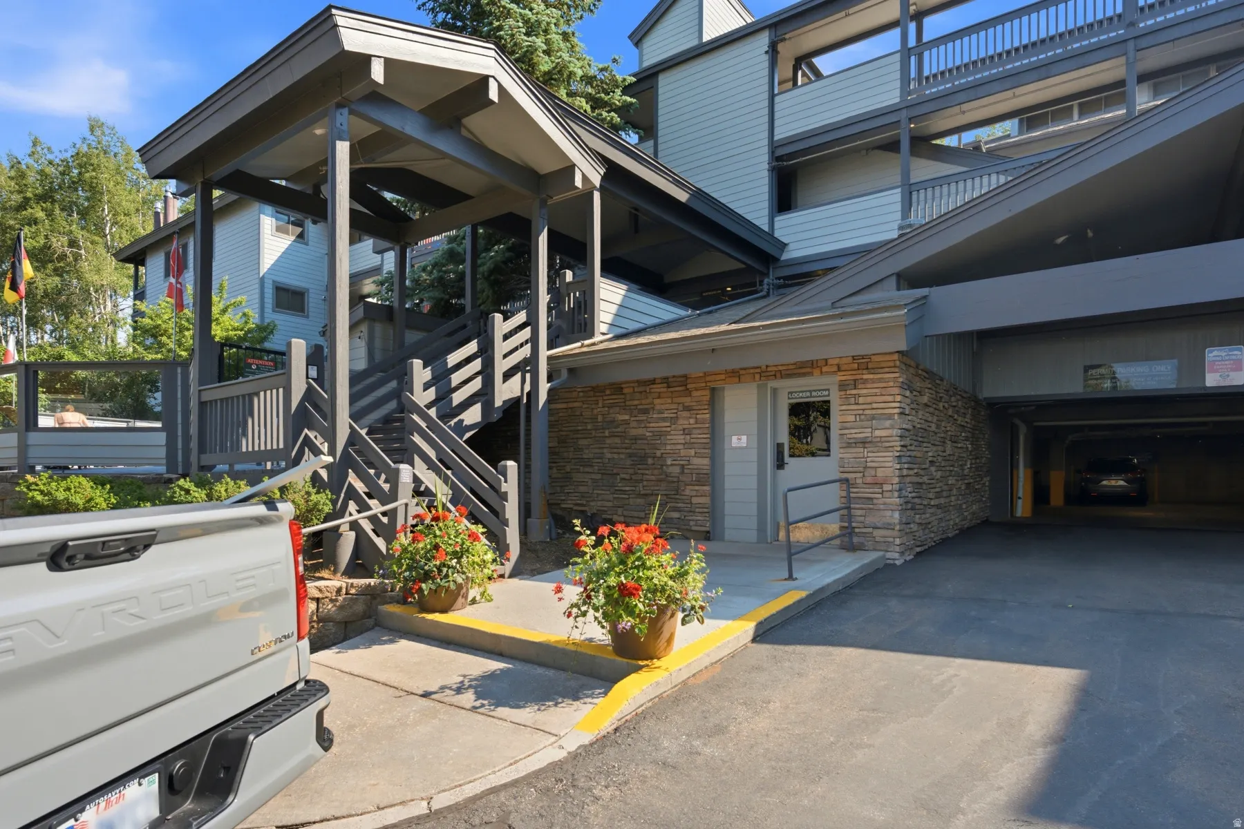 Multi-level building exterior featuring stacked stone accents and covered entryways