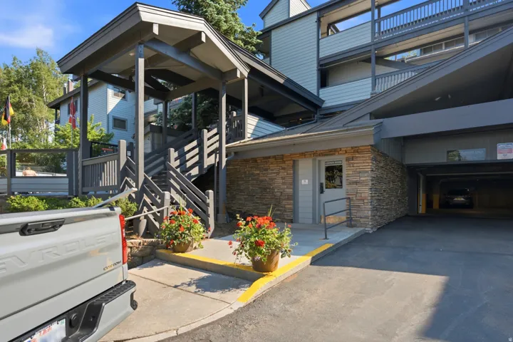 Multi-level building exterior featuring stacked stone accents and covered entryways