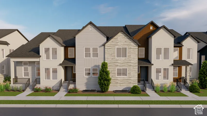 Contemporary townhome exterior featuring a multi-textured facade with stone accents, horizontal siding, and dark trim