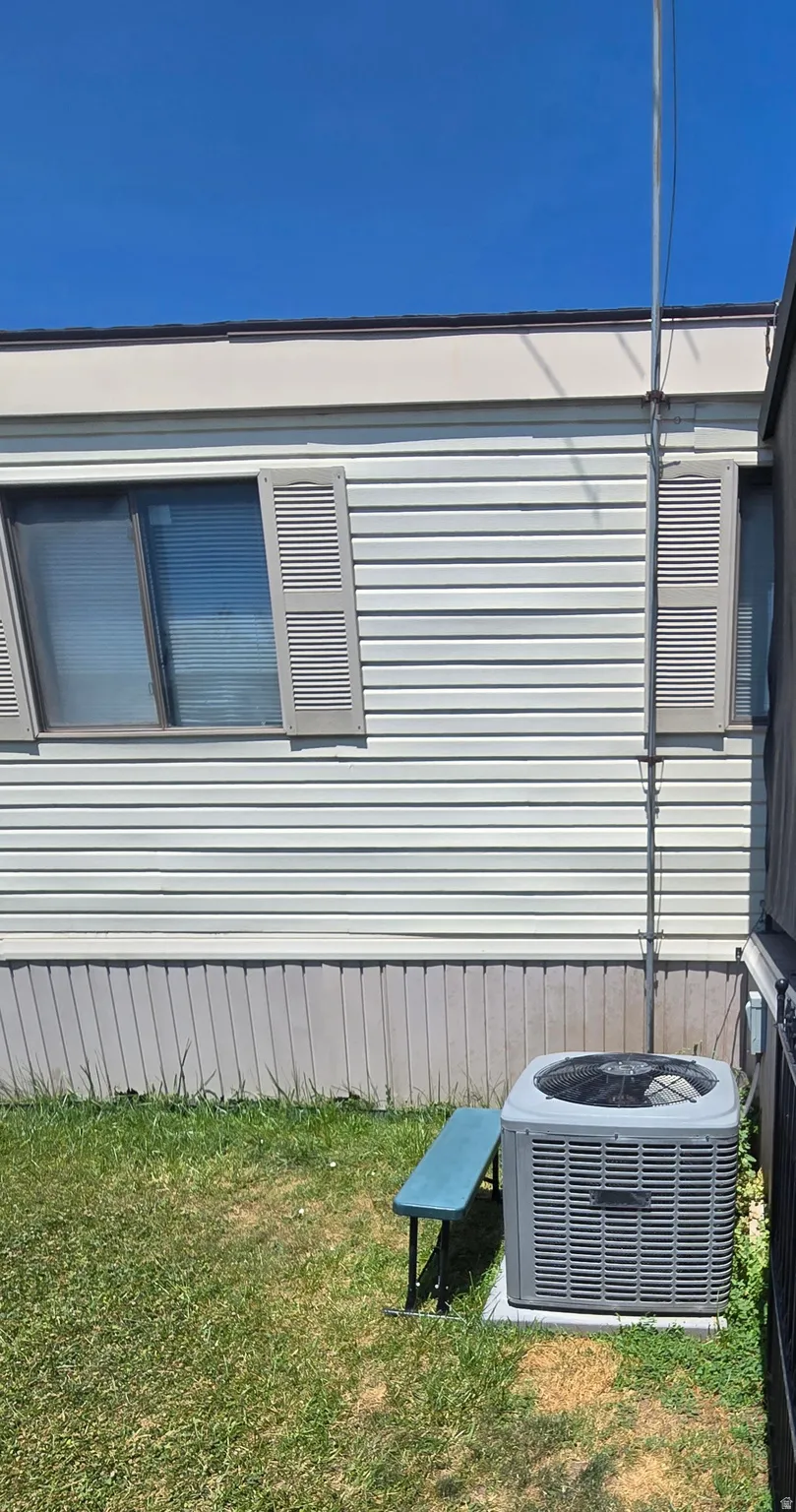 Exterior siding with louvered shutters and an integrated air conditioning unit