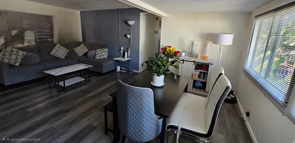 Open-concept living and dining area with wood-finish flooring
