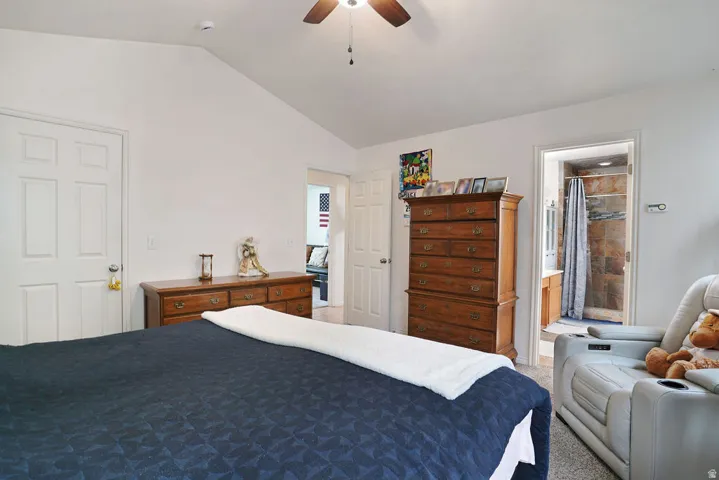Bedroom featuring a vaulted ceiling and a ceiling fan