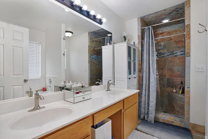 Double vanity with an integrated white countertop, undermount sinks, and brushed nickel faucets