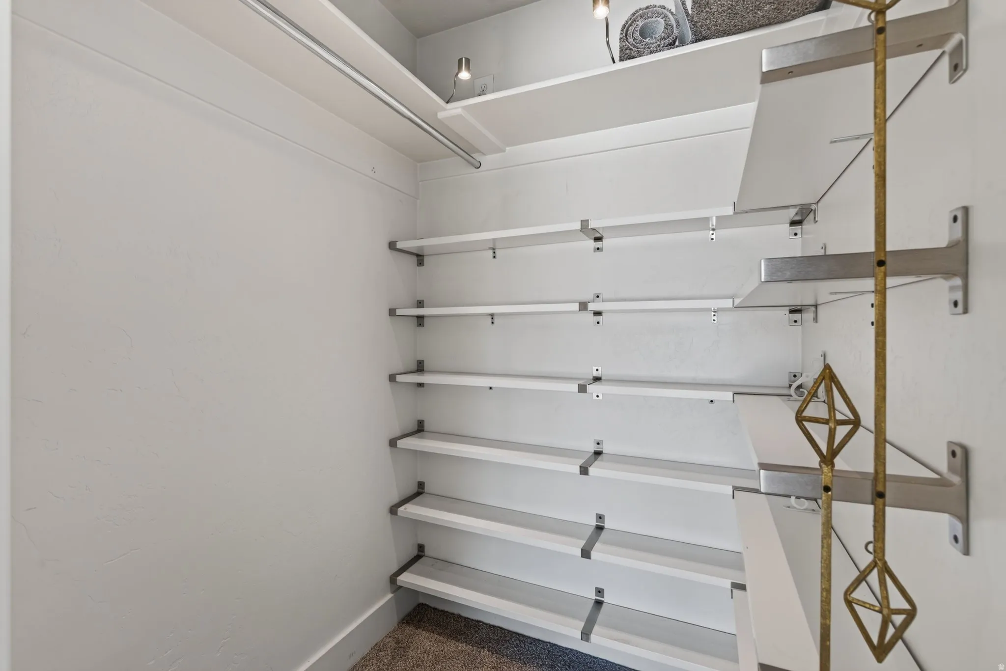 Custom closet system featuring multiple adjustable shelves and hanging rods