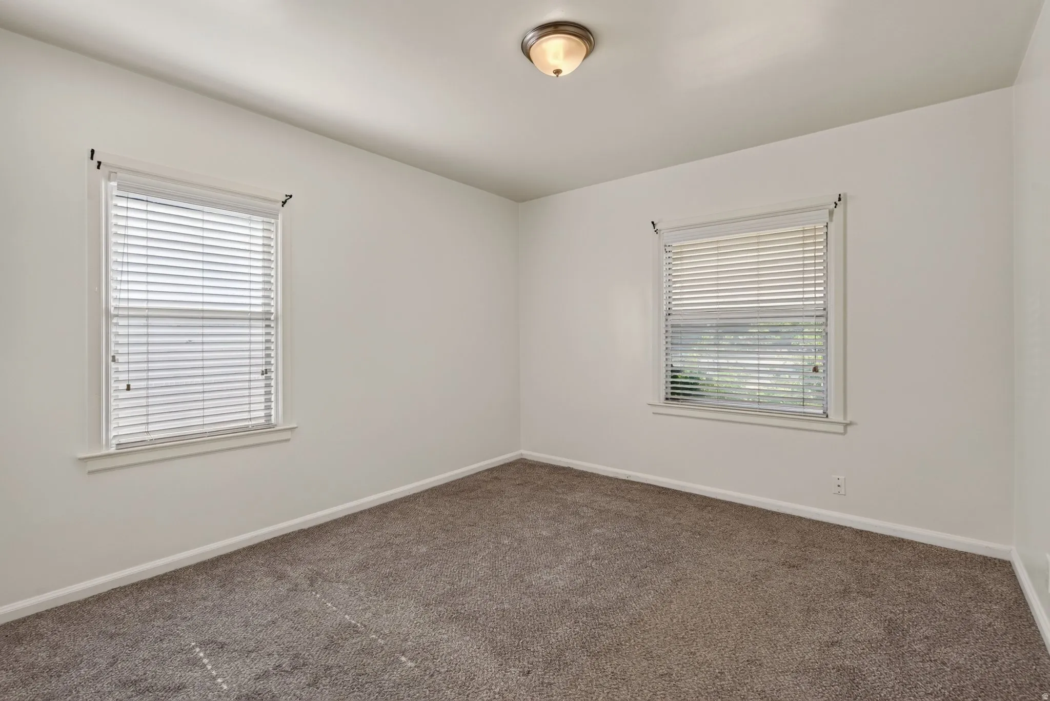 Neutral-toned interior with light wall paint and gray carpeting