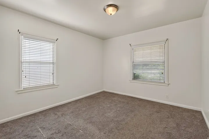 Neutral-toned interior with light wall paint and gray carpeting