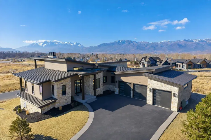 Modern architectural exterior with a multi-textured facade featuring stone and stucco