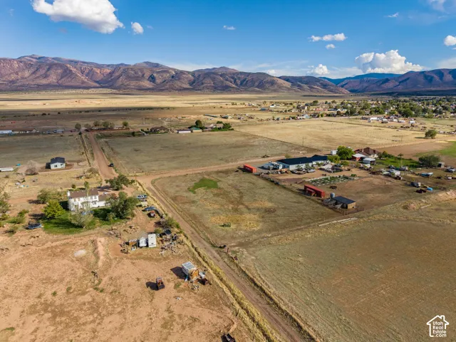 Aerial perspective of expansive acreage featuring mountain surroundings and unimproved land