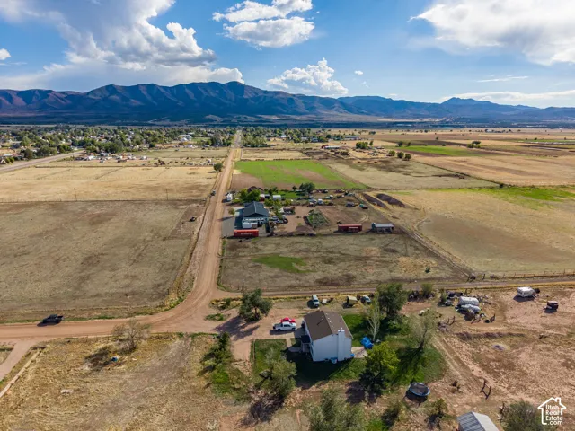 Aerial perspective showcasing expansive acreage with panoramic mountain scenery