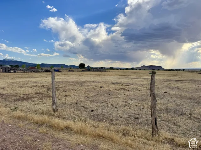 Expansive land parcel featuring natural, arid vegetation and distant mountain ranges